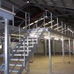 Industrial mezzanine in galvanized finish showing staircase & handrail