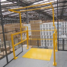 Up & over pallet gate in powder coated yellow finish complete with steel deck plate