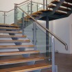 Feature staircase with hardwood timber treads, complete with bespoke stainless handrail